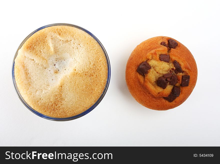 A top view shot of a a cup of coffee with muffins. A top view shot of a a cup of coffee with muffins