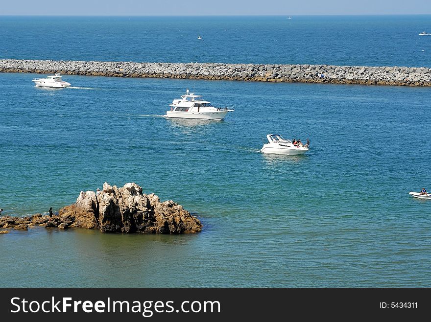 Harbor entrance with rock jetty at low tide. Harbor entrance with rock jetty at low tide