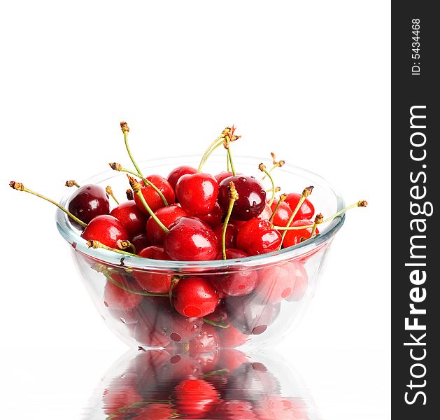 An image of ripe red cherries in a glass cup