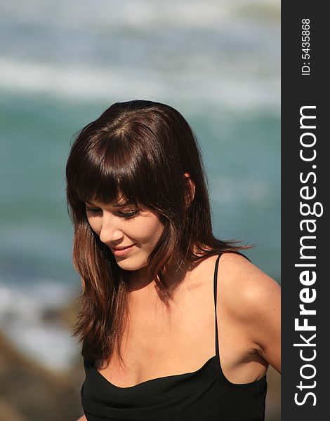 A beautiful white caucasian brunette woman with a shy expression on her face enjoying the summer. A beautiful white caucasian brunette woman with a shy expression on her face enjoying the summer