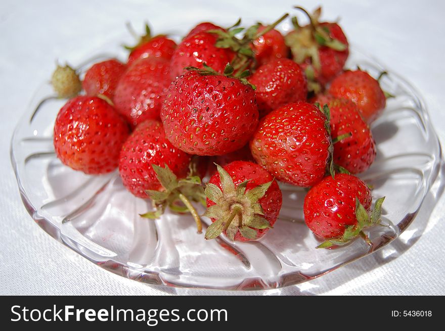 Red ripe Strawberrys heap on the glass plate. Red ripe Strawberrys heap on the glass plate