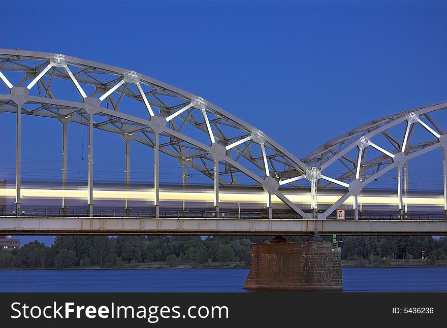 The night express train on the bridge across Daugava river. The night express train on the bridge across Daugava river.