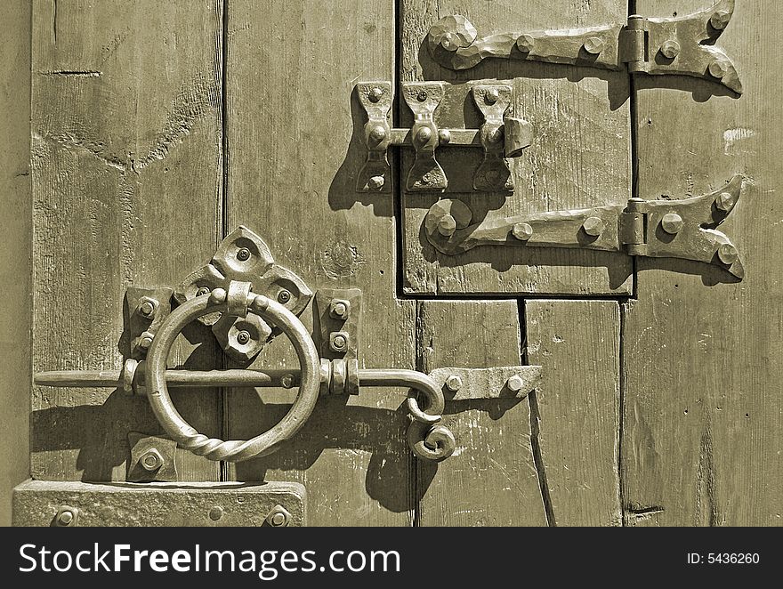 The iron lock on an old door. The iron lock on an old door.