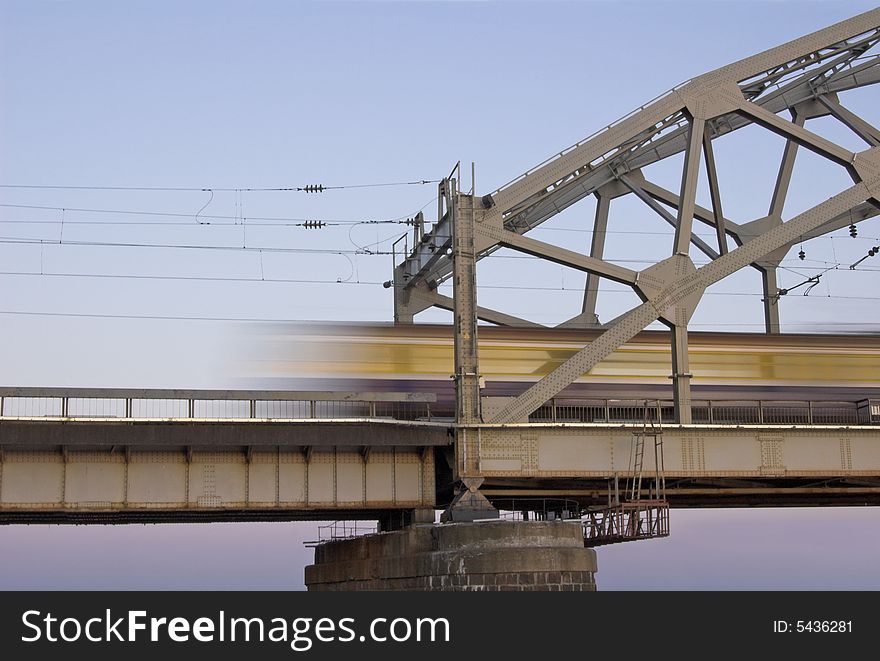 The morning train on the bridge across Daugava river. The morning train on the bridge across Daugava river.