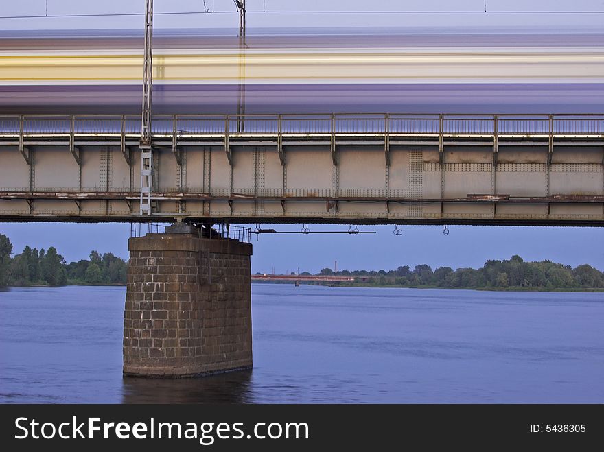 The morning express train on the bridge across Daugava river. The morning express train on the bridge across Daugava river.