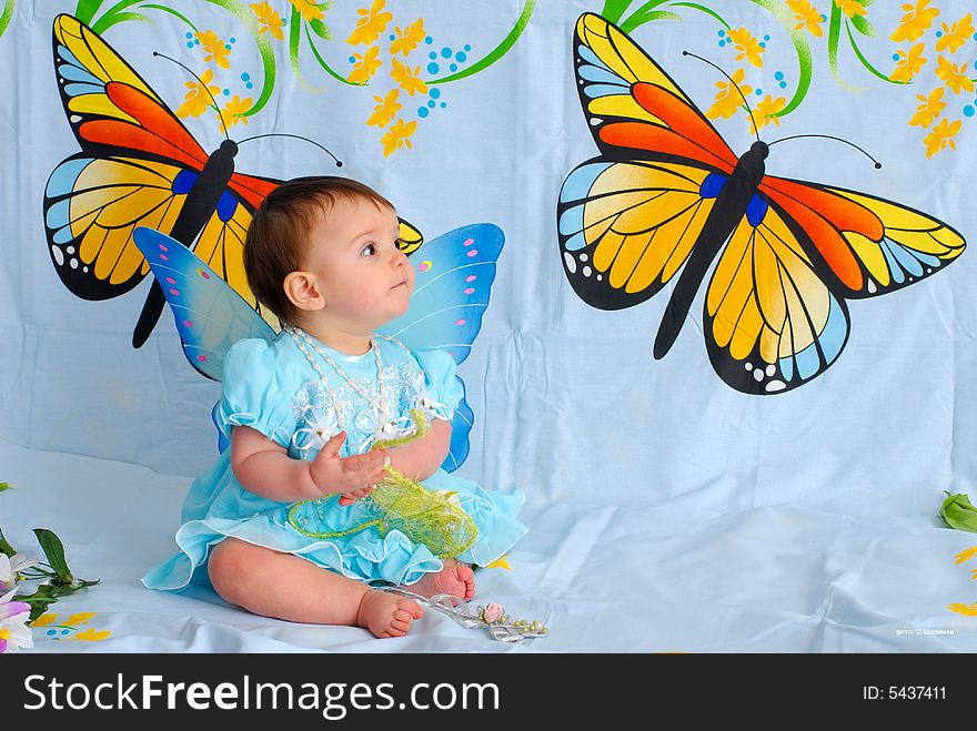 A picture of a sweet little girl in a fancy blue dress with butterfly wings. A picture of a sweet little girl in a fancy blue dress with butterfly wings