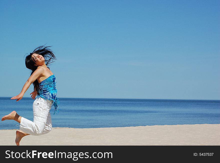 Active woman jumping on the beach. Active woman jumping on the beach