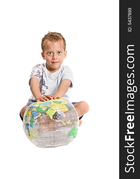 Young boy plays with globe