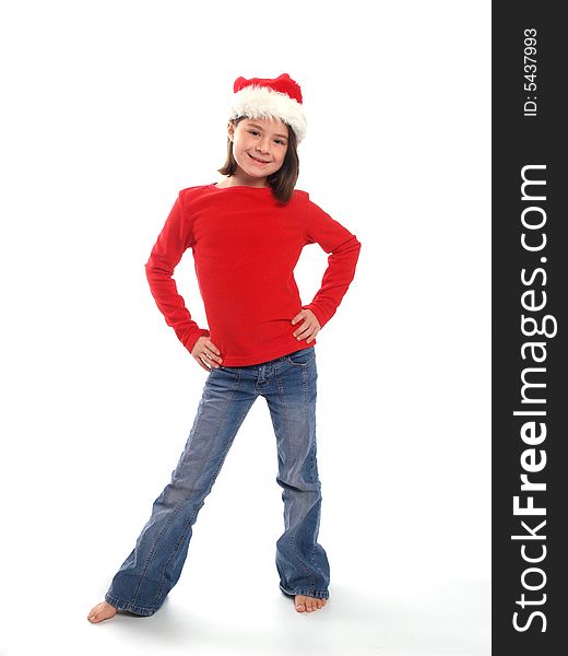 School aged girl wearing red shirt and Santa hat, perfect for the Christmas season. School aged girl wearing red shirt and Santa hat, perfect for the Christmas season