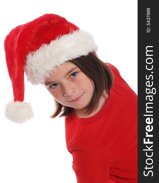 School aged girl wearing red shirt and Santa hat, perfect for the Christmas season. School aged girl wearing red shirt and Santa hat, perfect for the Christmas season