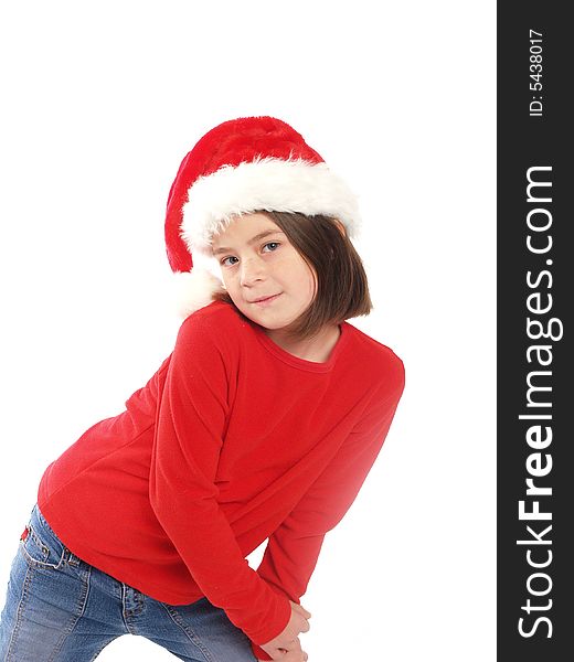 School aged girl wearing red shirt and Santa hat, perfect for the Christmas season. School aged girl wearing red shirt and Santa hat, perfect for the Christmas season