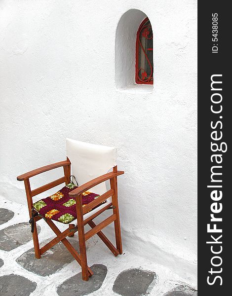 Lone chair beside old Mediterranean building in Greece. Lone chair beside old Mediterranean building in Greece