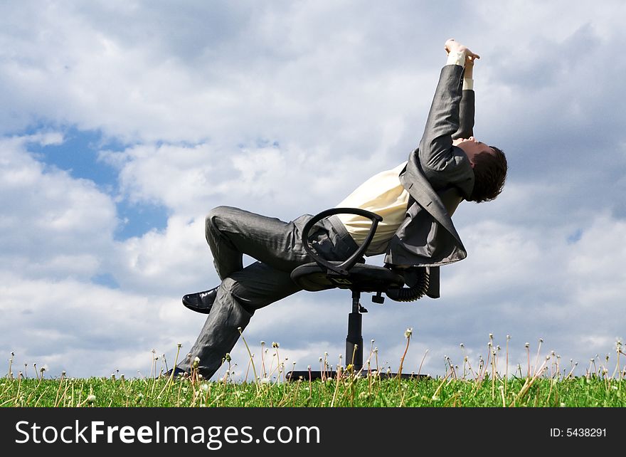 The young businessman sitting on a chair. The young businessman sitting on a chair