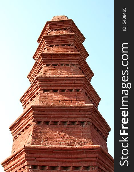 Red brick pagoda on background of sky