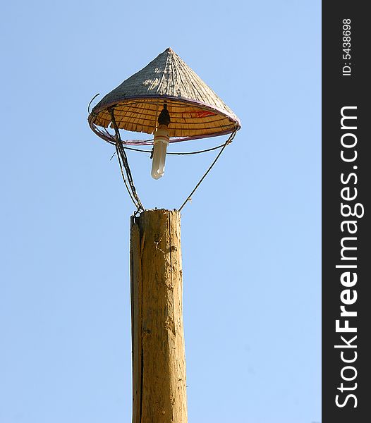 An old ancient wooden lamppost but with modern energy saving lamp