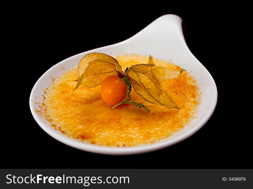 Ginger creme brulee isolated on black