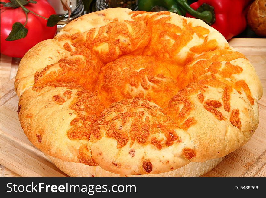 Fresh baked cheddar cheese roll loaf over white. Fresh baked cheddar cheese roll loaf over white.