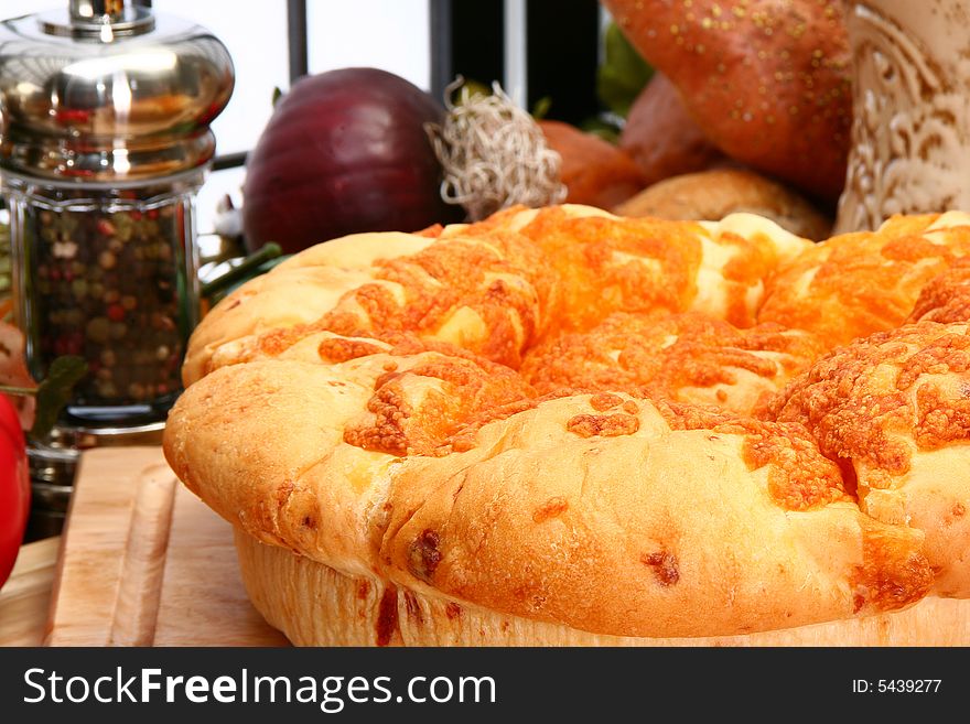 Fresh baked cheddar cheese roll loaf in kitchen or restaurant setting. Fresh baked cheddar cheese roll loaf in kitchen or restaurant setting.