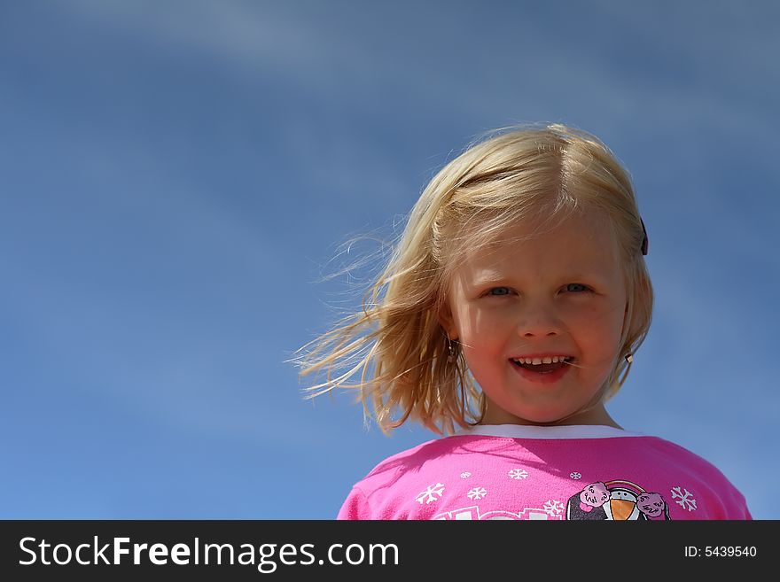 Portrait of smiling girl  over blue sky. Portrait of smiling girl  over blue sky