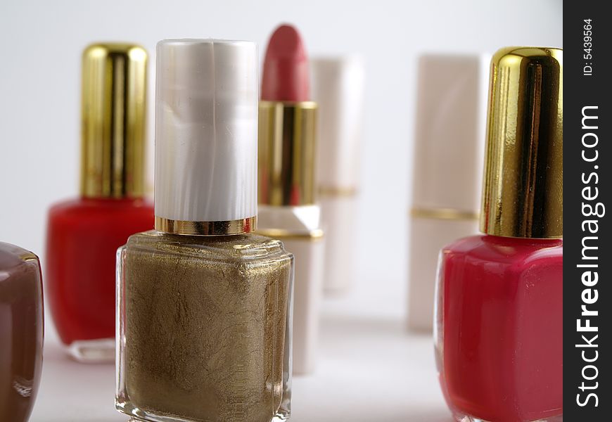 Nail Polishes in multiple colors. close up. white lipstick cases blurred, staggered in the background. Nail Polishes in multiple colors. close up. white lipstick cases blurred, staggered in the background.