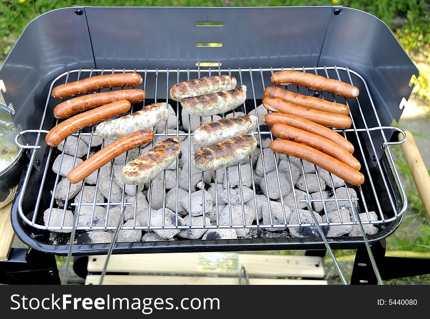 Sausages cooking on a barbecue. Sausages cooking on a barbecue