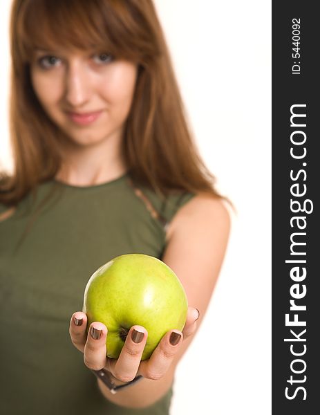 Fitness girl with green apple, focus on fruit, isolated on white background