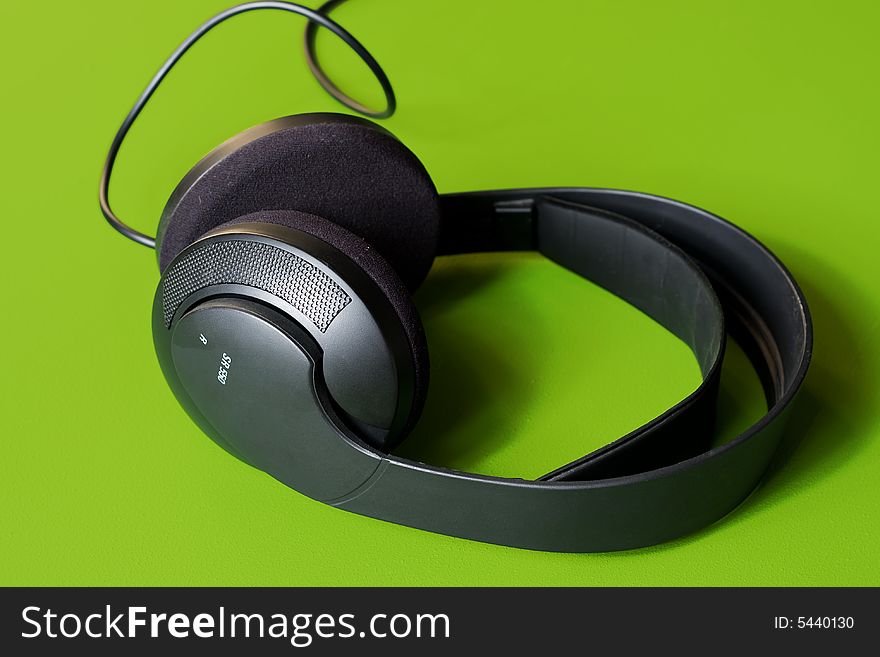 Black Headphones on green background