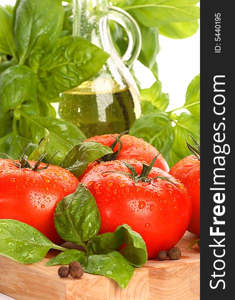 Fresh tomatoes with basil on kitchen table