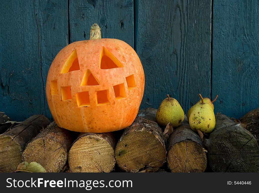 Orange pumpkin against a blue wood wall. Orange pumpkin against a blue wood wall