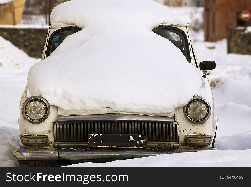 The old, Soviet, thrown car. It is removed on one of streets of the Russian city. Mark of the car Volga. The old, Soviet, thrown car. It is removed on one of streets of the Russian city. Mark of the car Volga.