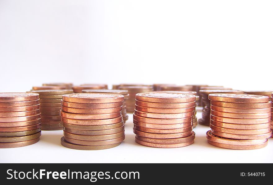 Piled coins on white background