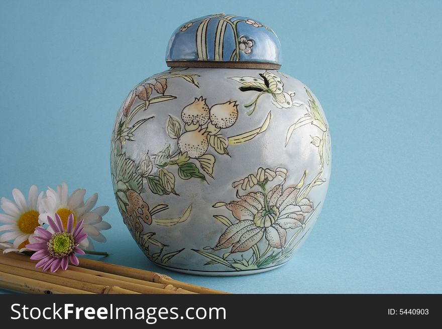 Chinese jug with tap in blue background