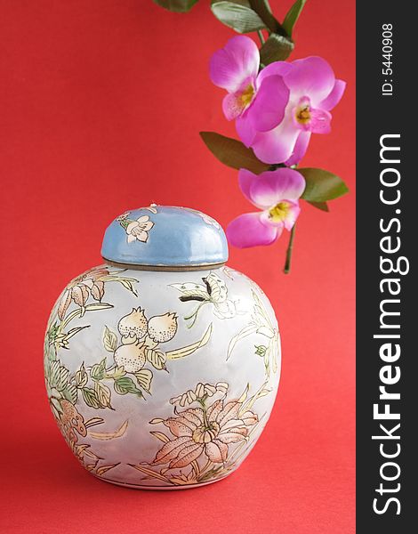 Blue oriental jug and flowers in red background. Blue oriental jug and flowers in red background