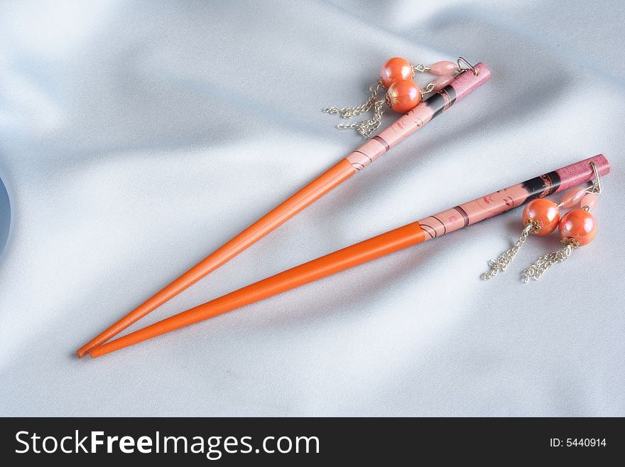 Orange geisha hairpins on blue satin material. Orange geisha hairpins on blue satin material