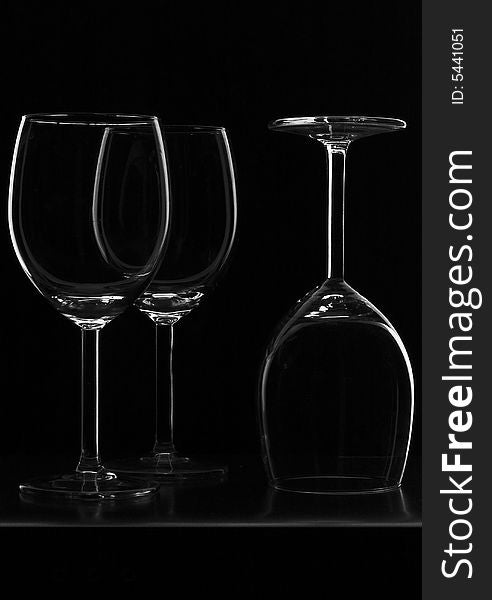 Outlines of three glass glasses in low-key