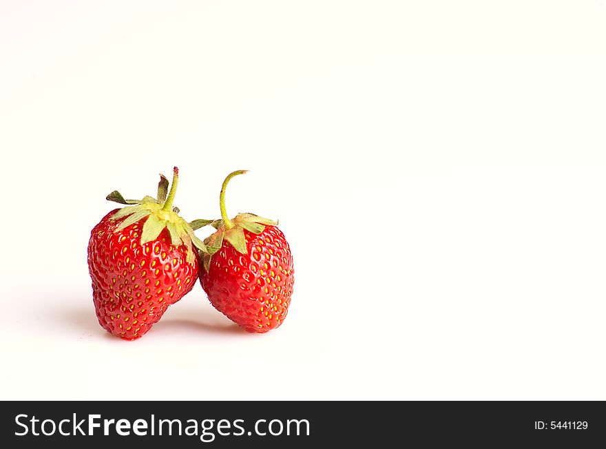 Two strawberries on white background, lots of copy space