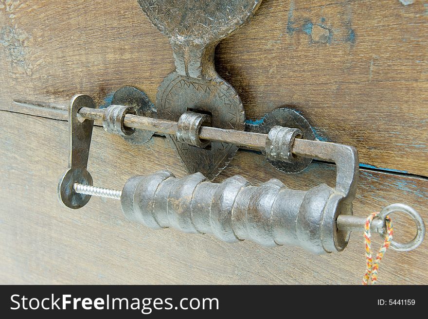 Antique locking mechanism or padlock on a restored antique chest with a hinged bracket lock.