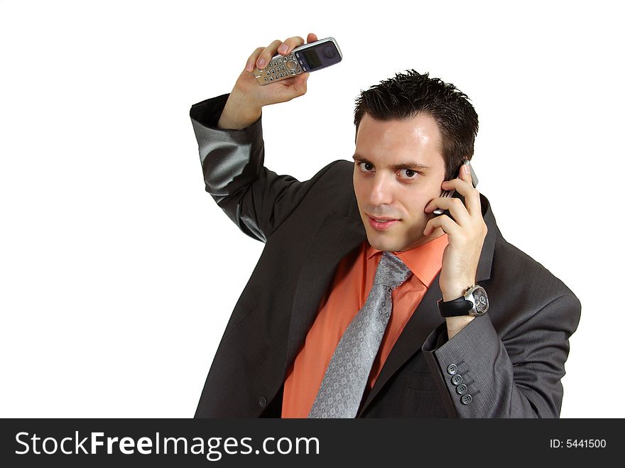 A young businessman, talking over one phone, while holding another one up in the air. A young businessman, talking over one phone, while holding another one up in the air