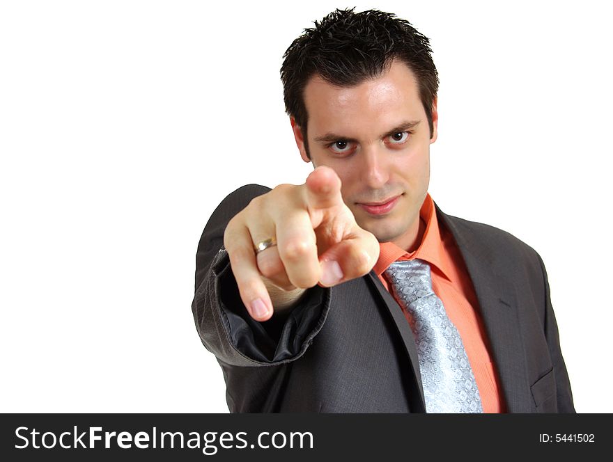 A young business man, wearing a suit, pointing his index finger towards the camera. A young business man, wearing a suit, pointing his index finger towards the camera