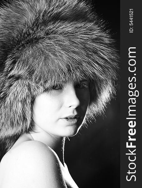Nude girl wearing a fur hat