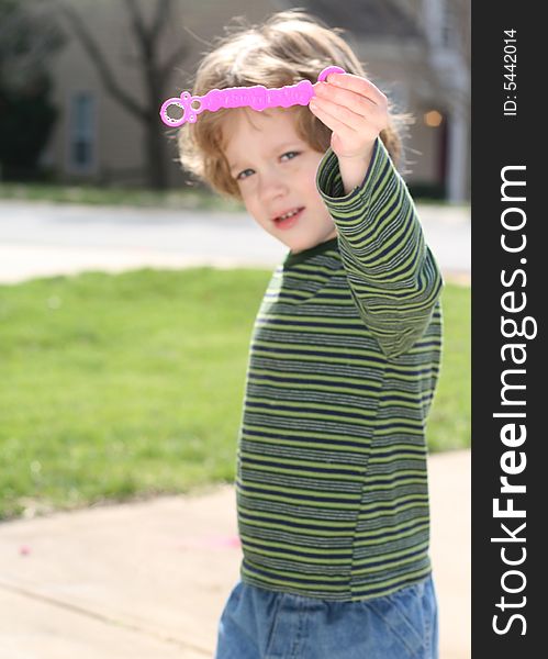 Four year old boy blowing bubbles