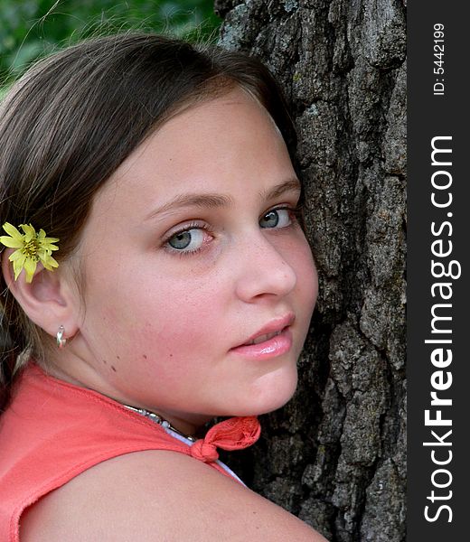 Teenage Girl With Flower By Tree