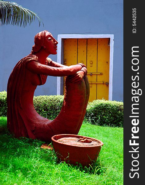 The sculpture of a young woman on road side of Goa town. The sculpture of a young woman on road side of Goa town.