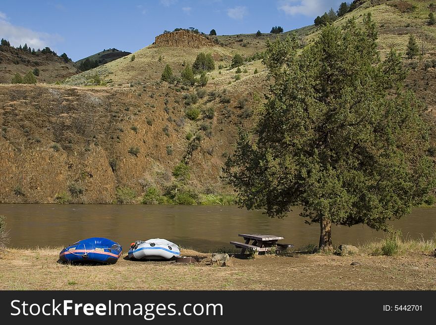 Two rafts beached on the shore of a river in Oregon. Two rafts beached on the shore of a river in Oregon