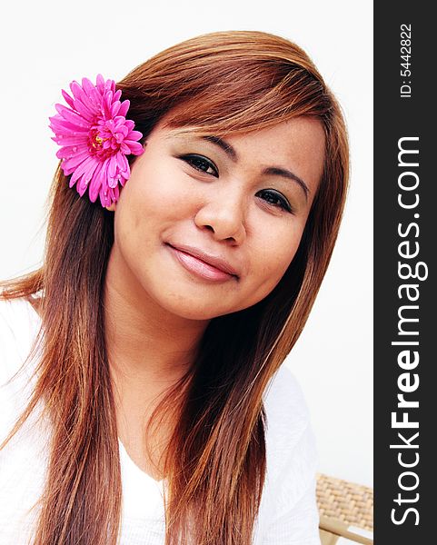 Portrait of a beautiful young Thai woman with a flower in her hair. Portrait of a beautiful young Thai woman with a flower in her hair.