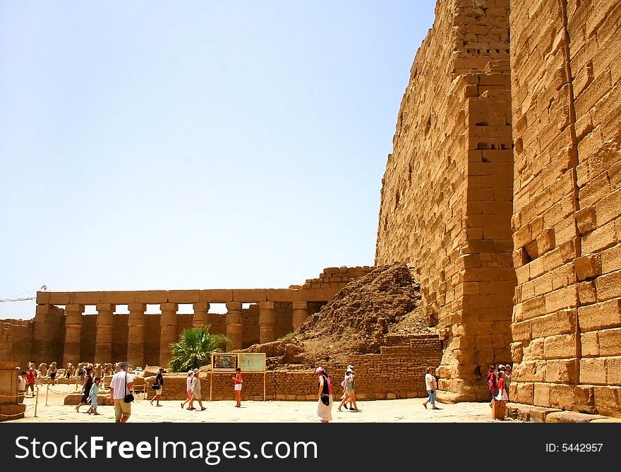 Ancient Luxor ruins, Egypt which are examined by tourists in hot day. Ancient Luxor ruins, Egypt which are examined by tourists in hot day