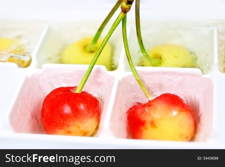 Light orange frozen cherries in some small boxes. Light orange frozen cherries in some small boxes