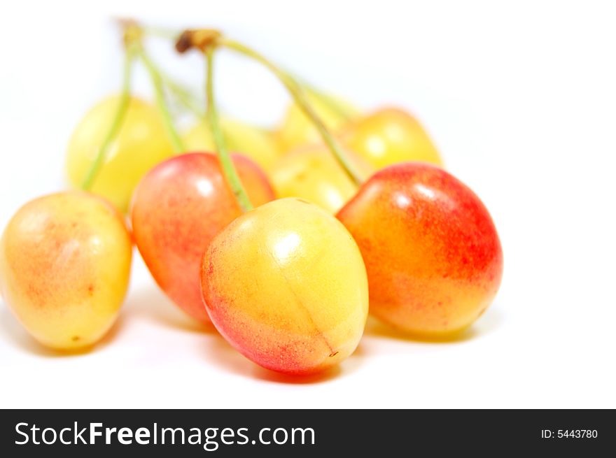 Light orange cherries isolated on white