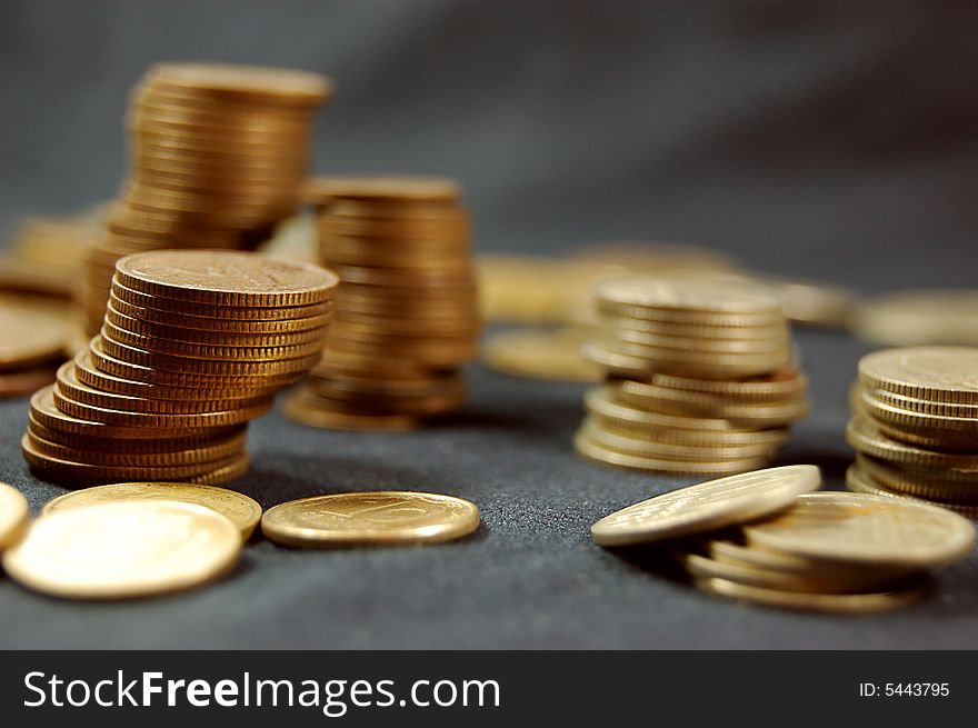 A pile of golden coins on dark background. A pile of golden coins on dark background