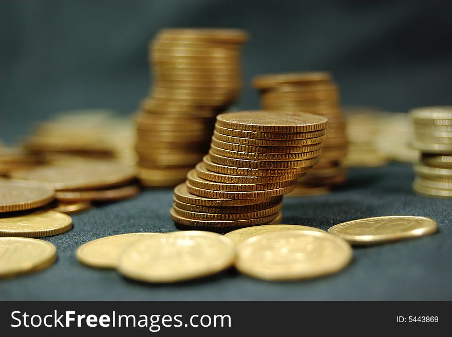 A pile of golden coins on dark background. A pile of golden coins on dark background